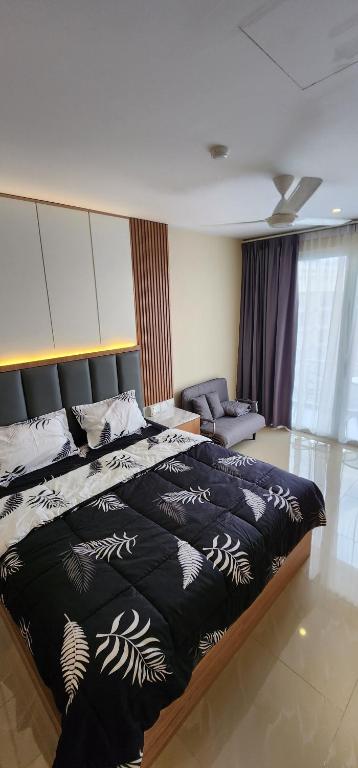 ein Schlafzimmer mit einem großen Bett und einem Sofa in der Unterkunft Nagoya Thamrin City Apartment High Floor in Nagoya