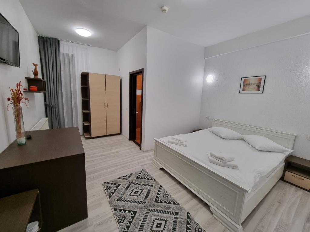 Postel nebo postele na pokoji v ubytování Hotel Perla Oltului
