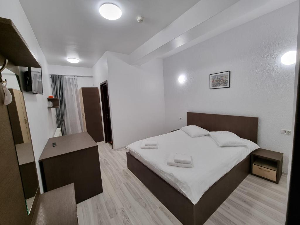Postel nebo postele na pokoji v ubytování Hotel Perla Oltului