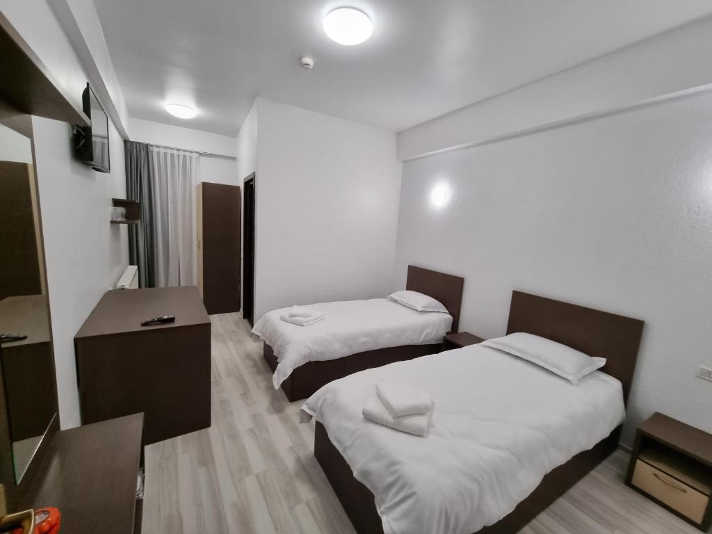 Postel nebo postele na pokoji v ubytování Hotel Perla Oltului