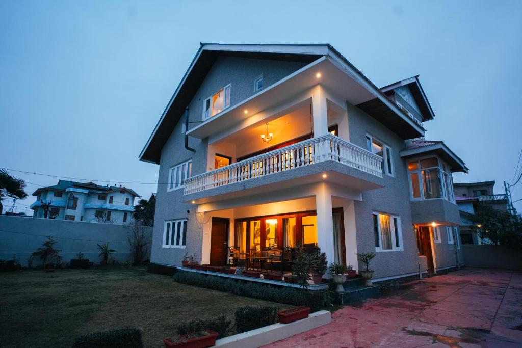 a large house with a balcony on top of it at Anand Homestay in Srinagar