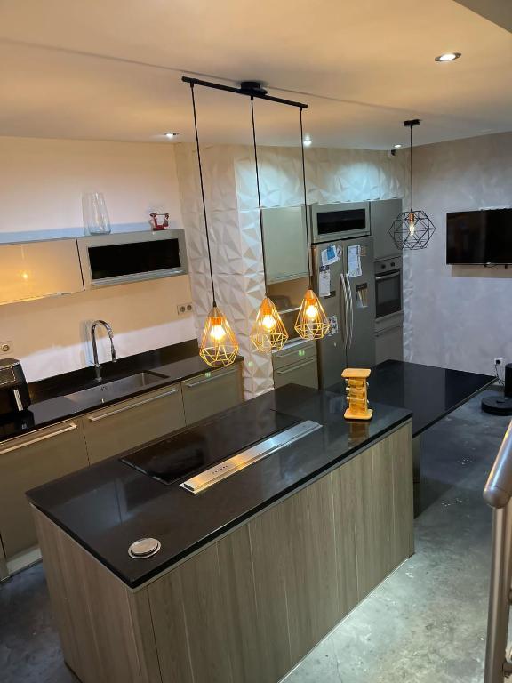 a kitchen with a black counter top and appliances at JD HOME in Beauvais