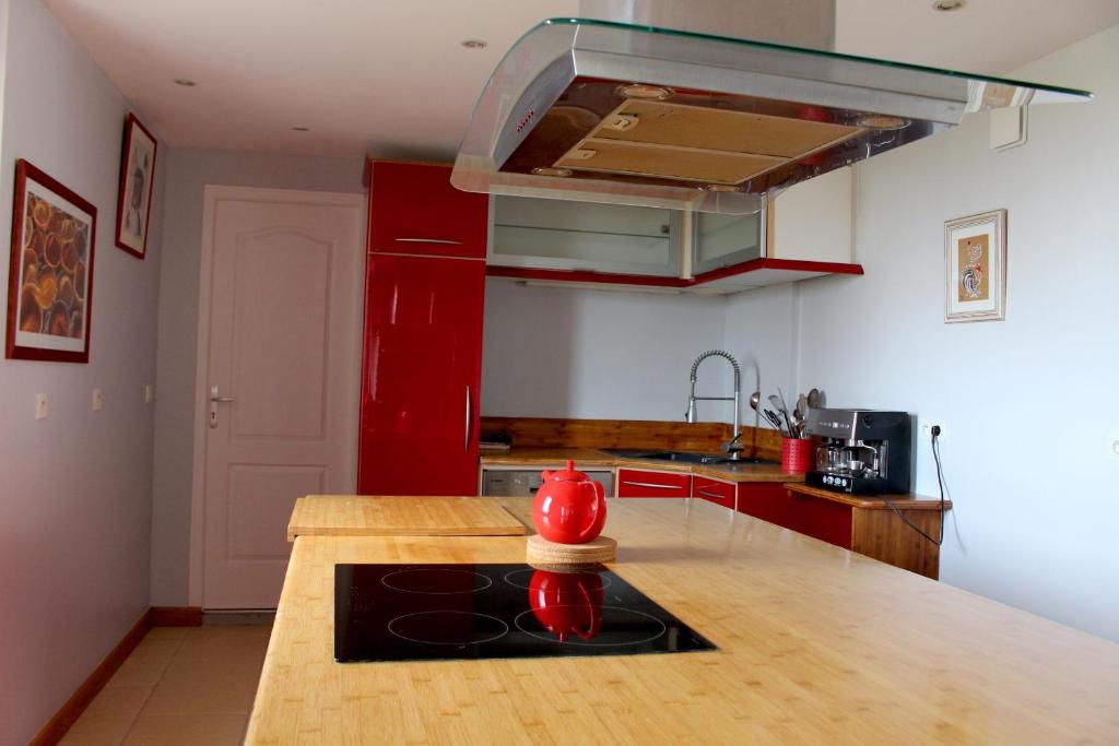 a kitchen with a red refrigerator and a wooden counter top at Domaine du Clos Fleuri - Spa in Honfleur
