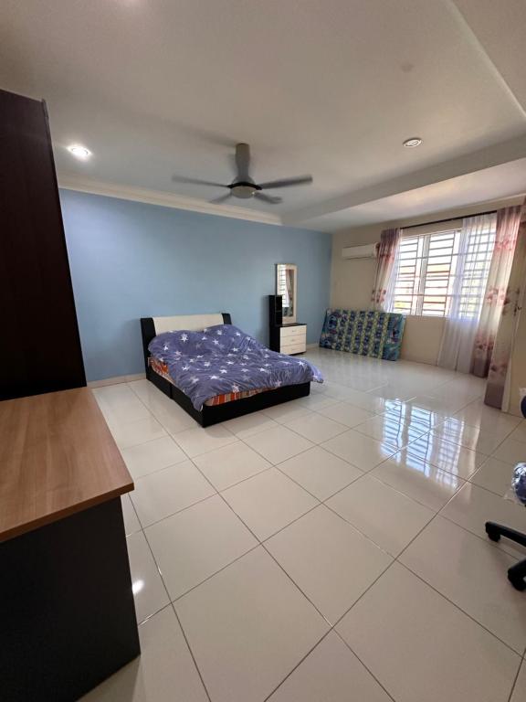 a bedroom with a bed on a tiled floor at DOUBLE EE homestay in Sitiawan