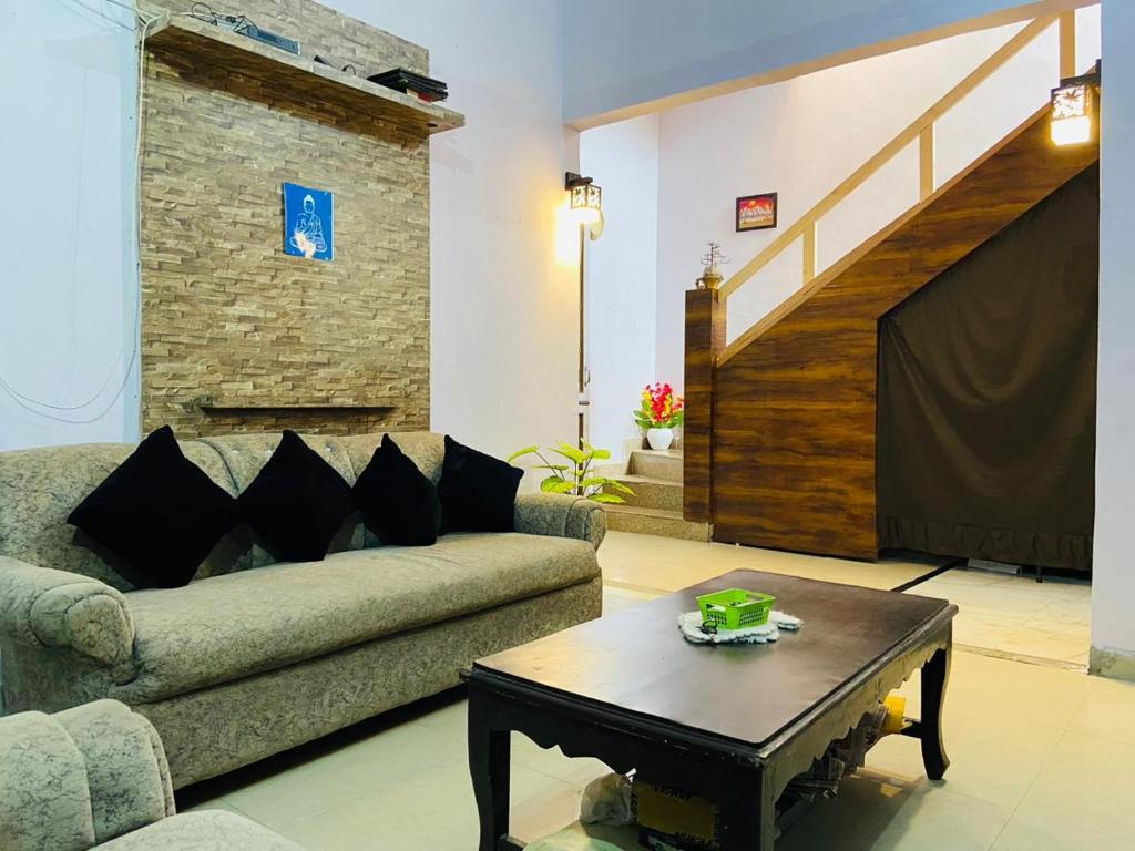 a living room with a couch and a table at Green lounge Homestay in Amritsar
