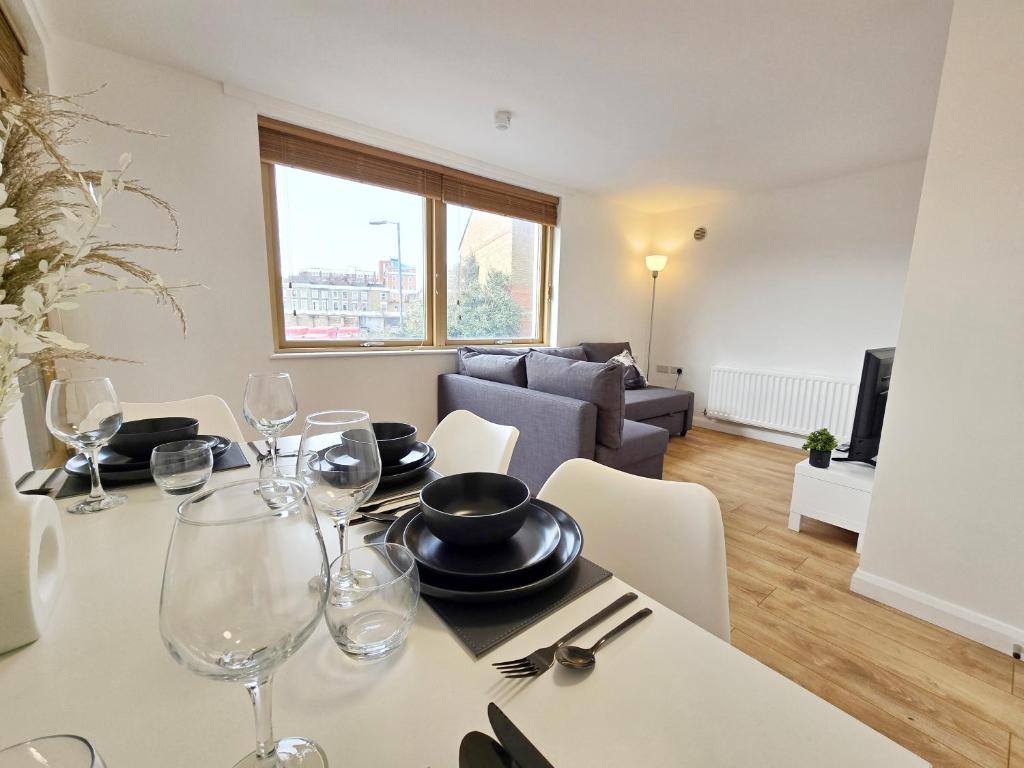 a dining room with a table with wine glasses at King’s Cross & Camden : Stylish Flat in London