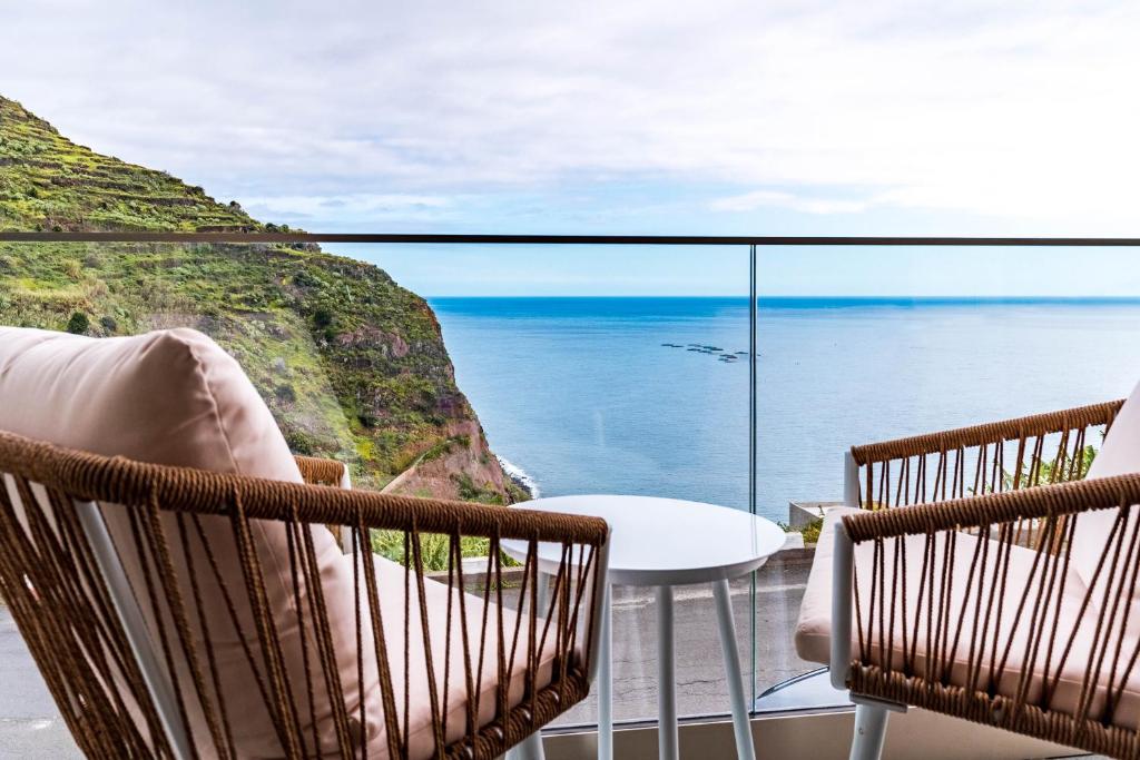 a balcony with a view of the ocean at One Sweet World in Calheta