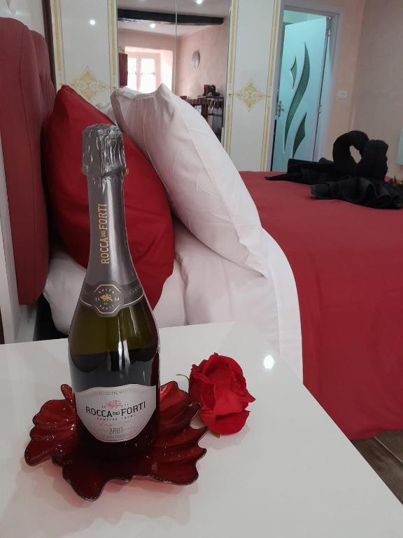 a bottle of wine on a table in a bedroom at IL NIDO Suite in Fiuggi