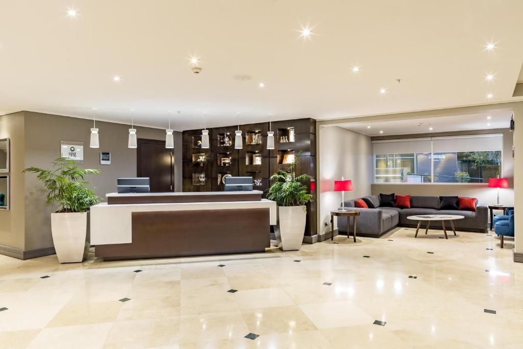 a lobby of a hotel with a reception desk at Four Points by Sheraton Santiago in Santiago