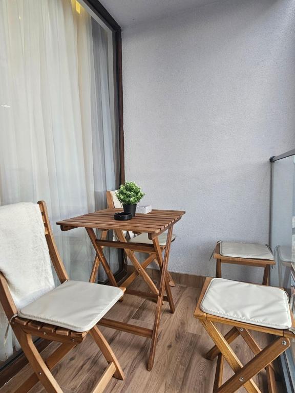 a room with a table and two chairs and a table at Borovi Deluxe Suite in Divčibare