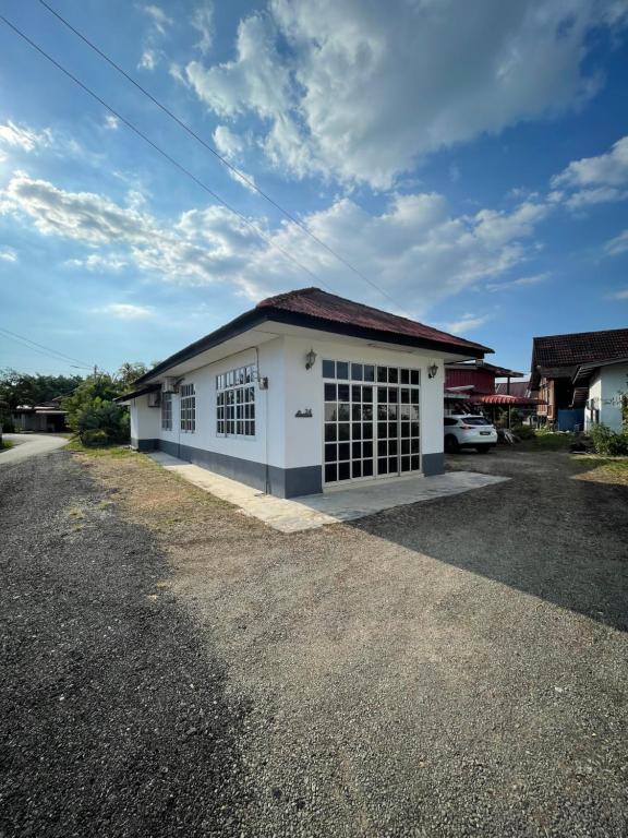 a white building with a lot of windows at Tokbah Homestay Alor Setar in Alor Setar