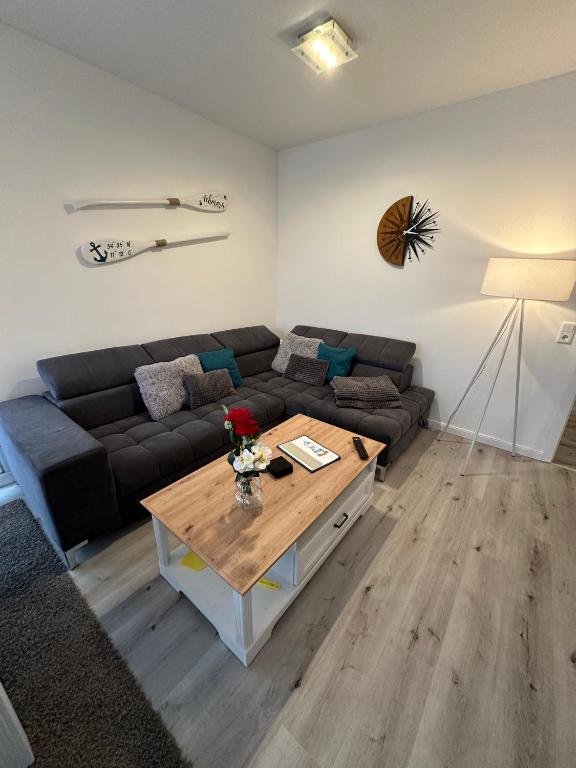 a living room with a couch and a coffee table at Inseloase in Fehmarn