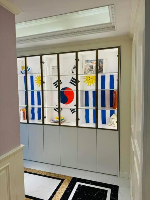 a room with glass windows with flags on them at Luxury Apartment at Zaisan in Ulaanbaatar