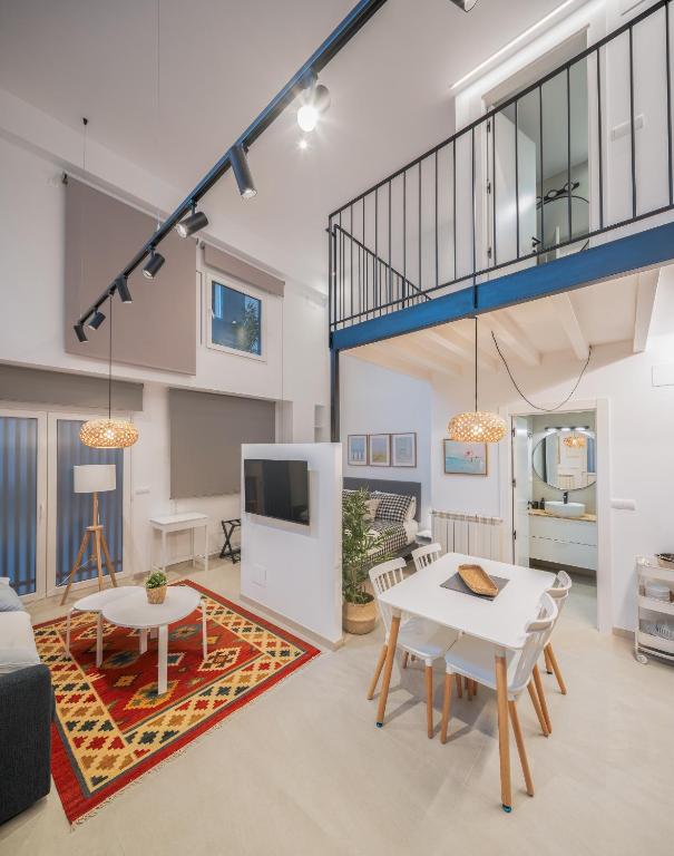 a living room with a white table and a tv at Apartamentos Bahía&Arena - Centro in Santander