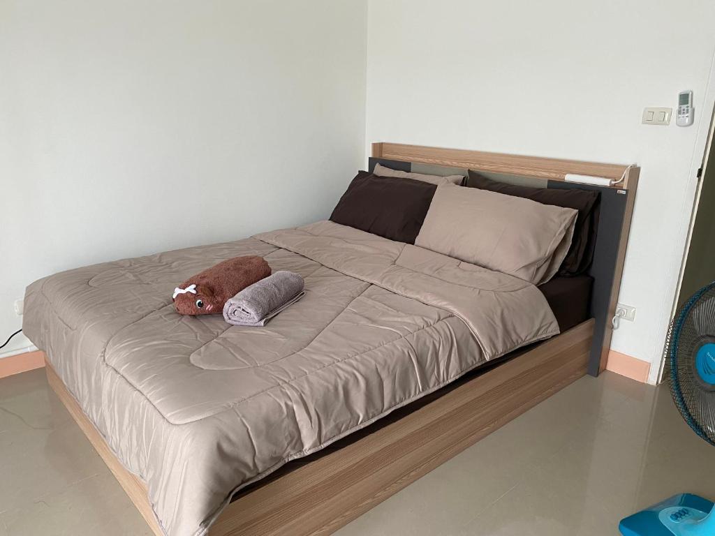 a bed with a stuffed animal on top of it at Studio Apartment in Phuket Town