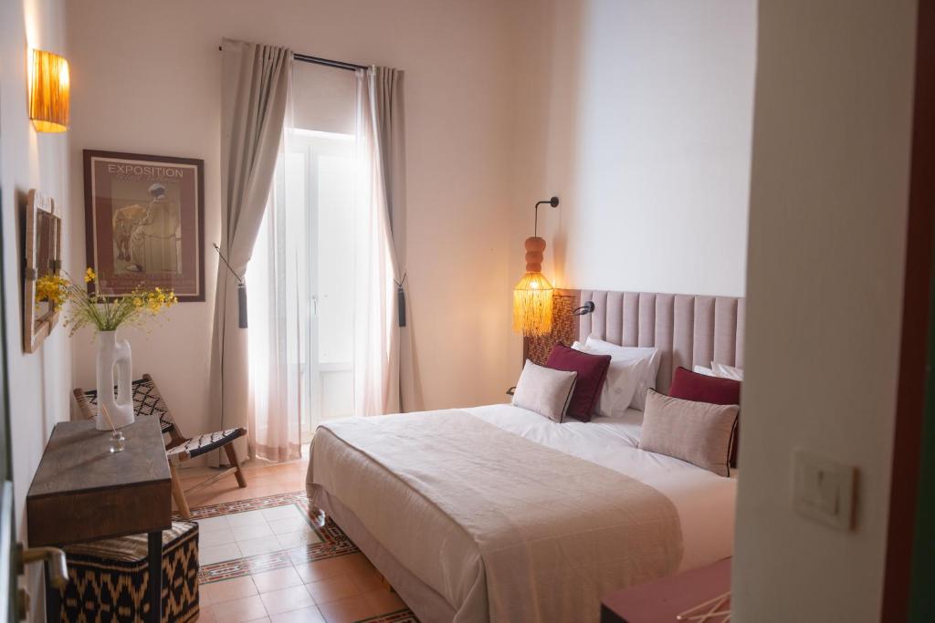 a hotel room with a bed and a window at Le Palazzo in Essaouira