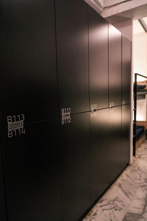 a row of elevator doors with numbers on them at Meeting Mates Hostel in Taipei