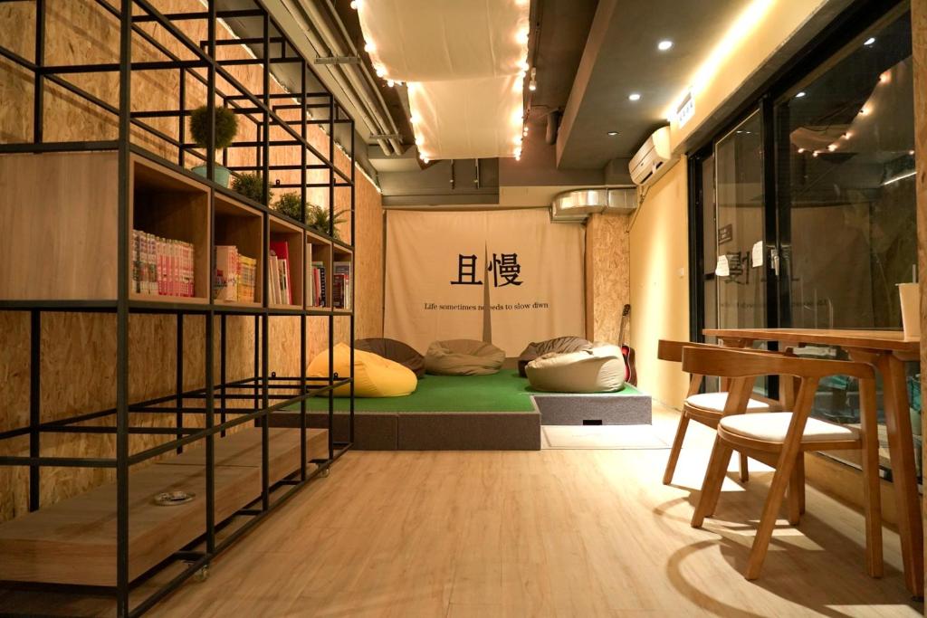 a room with a bed with pillows on it at Meeting Mates Hostel in Taipei