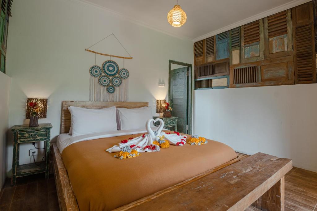 ein Schlafzimmer mit einem großen Bett mit Blumen darauf in der Unterkunft Munduk Farmhouse in Munduk