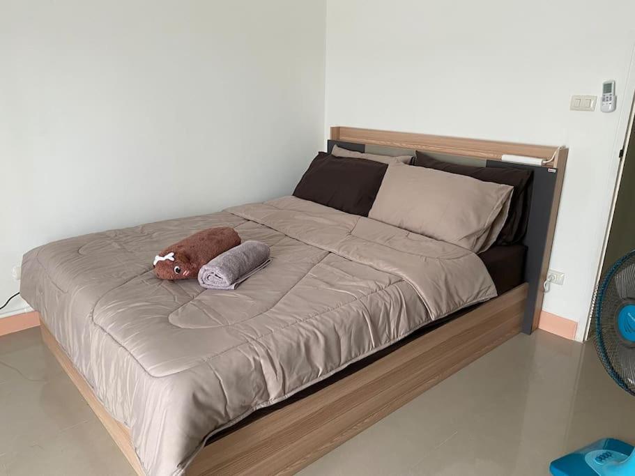 a bed with a stuffed animal on top of it at Superb studio Apartment in Ban Na Khua