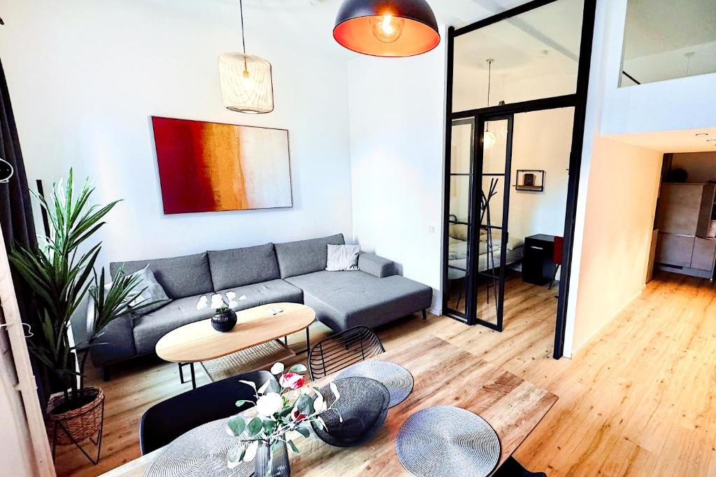 a living room with a couch and a table at Inner City Design Loft in Innsbruck