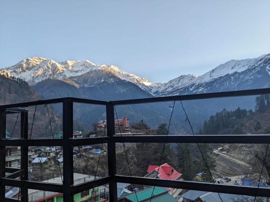 a view of a mountain range with snow covered mountains at Vigyan Guest House Tosh in Tosh