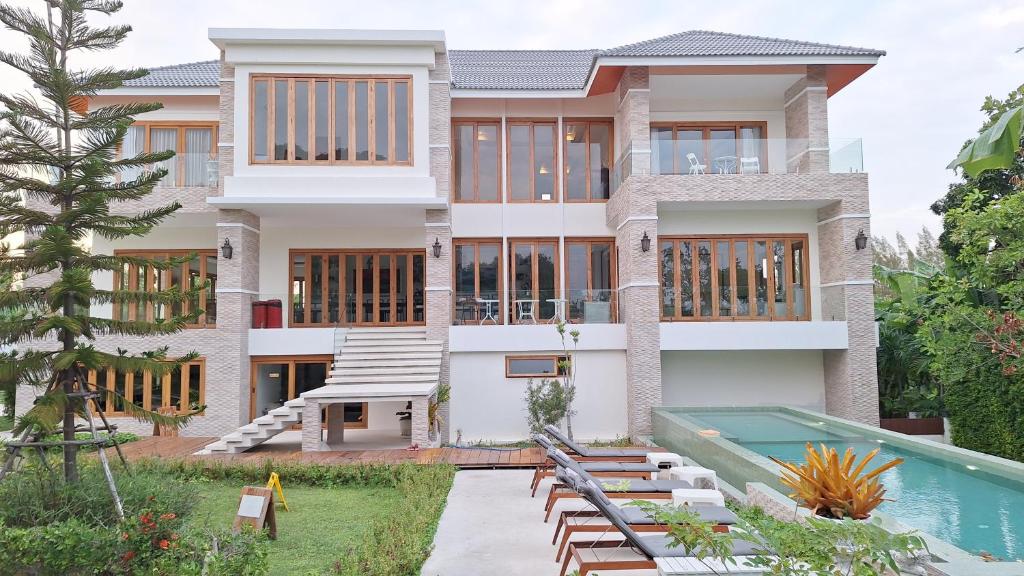 a house with a swimming pool in front of it at Nichahome Luxury Villa in Hua Hin
