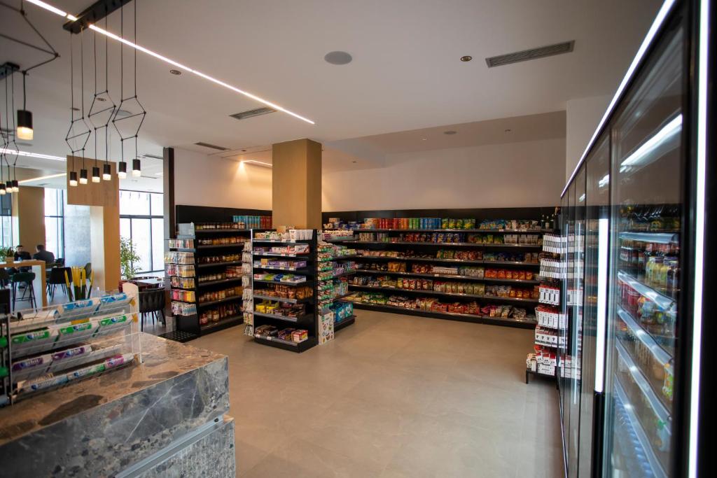 a store aisle with many shelves of products at Resort Zdrava in Savër