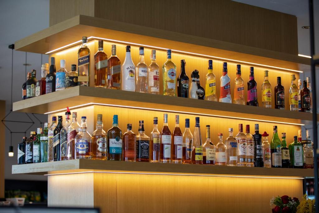 a display of bottles of alcohol on a shelf at Resort Zdrava in Savër