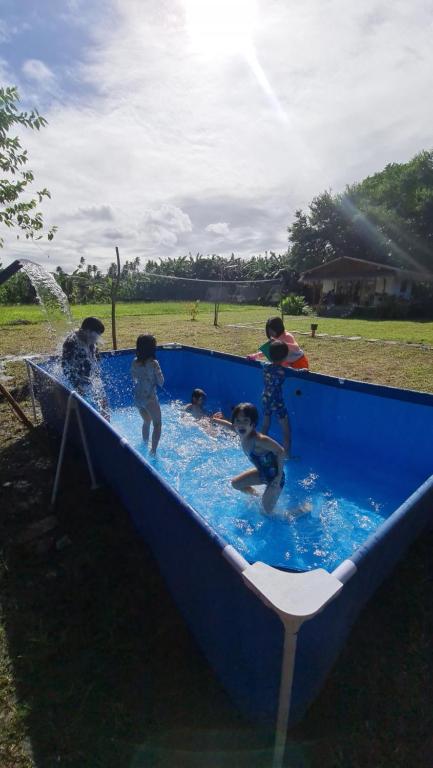 a group of children playing in a swimming pool at Casa Juan Farm in Candelaria
