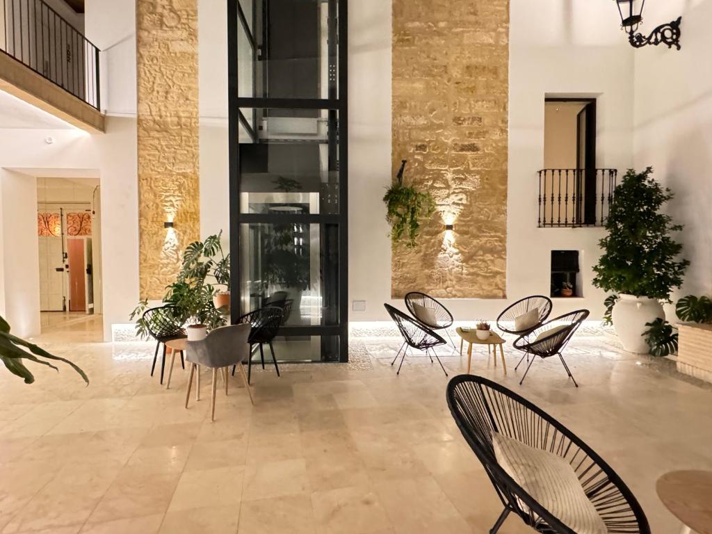 a living room with chairs and a table at Casa Boutique Navarro in Montilla