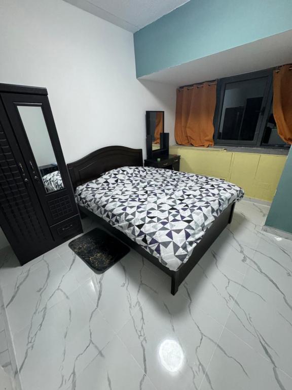 a bedroom with a bed sitting on the floor at Studio near Burj khalifa (emirates tower metro station) in Dubai