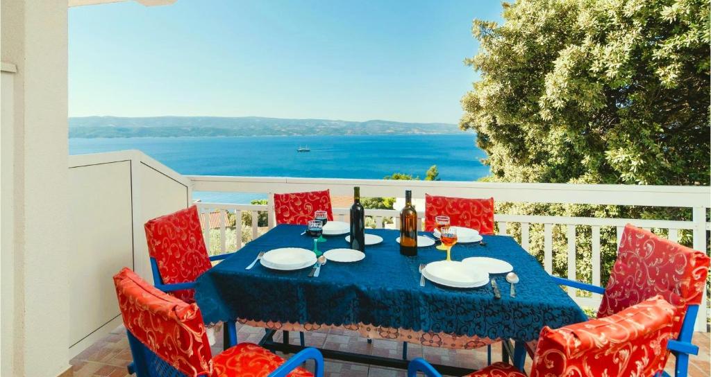 einen blauen Tisch und Stühle auf einem Balkon mit Meerblick in der Unterkunft Villa Roing S in Stanići