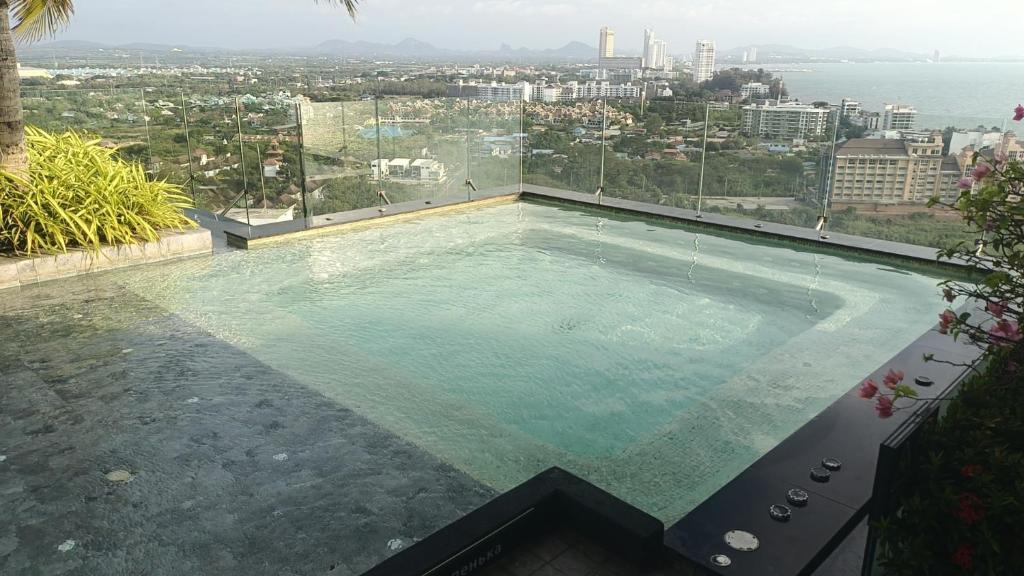 a swimming pool with a view of the city at The Riviera Monaco in Na Jomtien