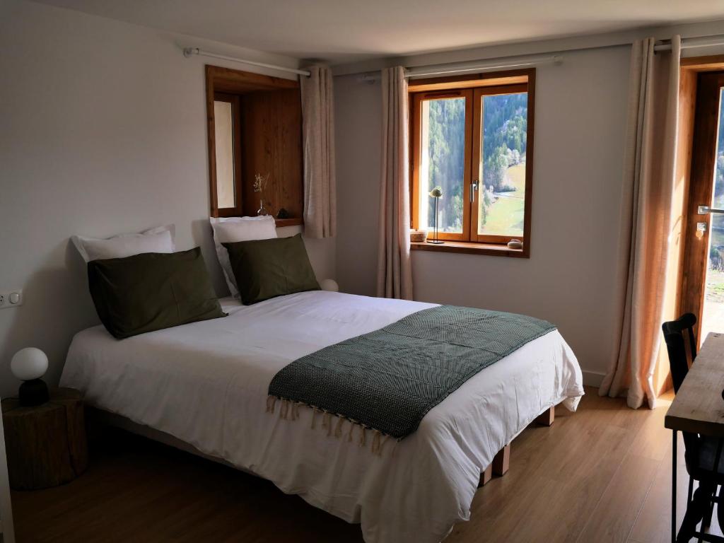- une chambre avec un grand lit et une fenêtre dans l'établissement La ferme d'Hauteluce - Chambre d'hôtes, à Hauteluce