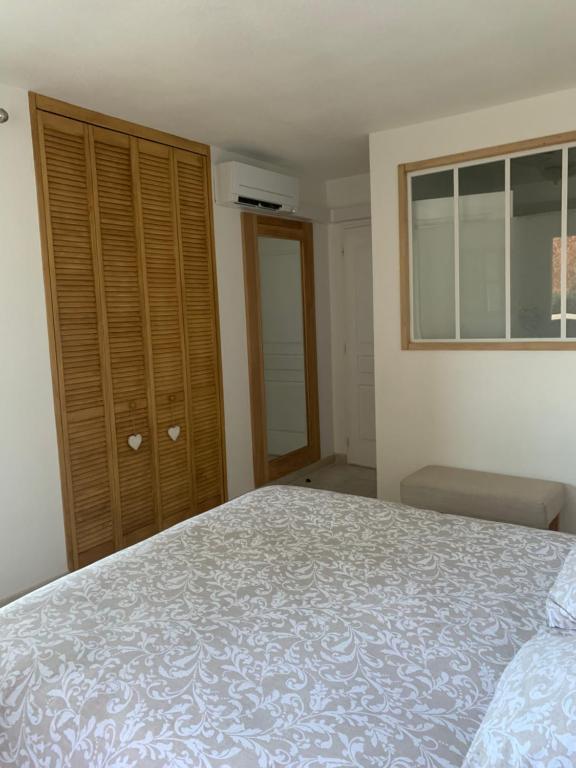 ein Schlafzimmer mit einem Bett und einer Kommode in der Unterkunft Chambre 2 dans un petit paradis in La Londe-les-Maures
