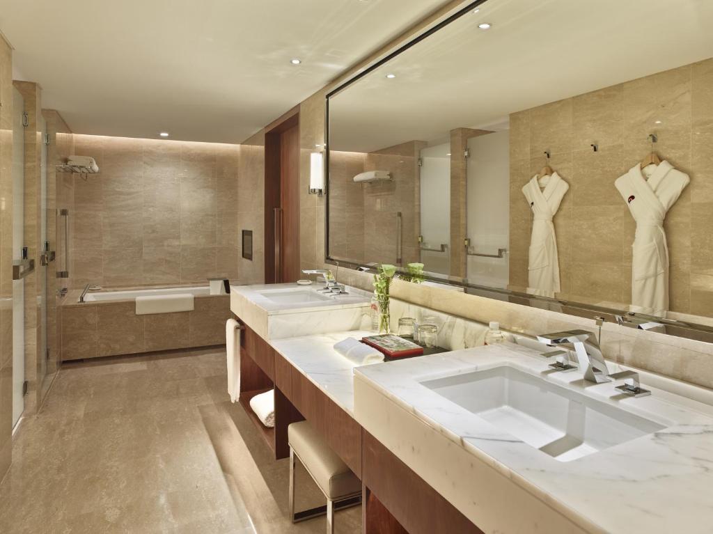 a bathroom with two sinks and a large mirror at White Swan Hotel in Guangzhou
