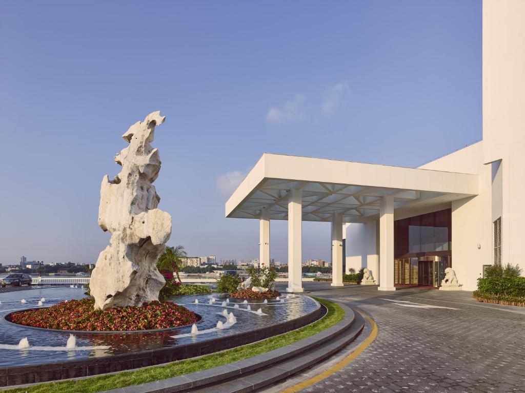 a water fountain in front of a building at White Swan Hotel in Guangzhou