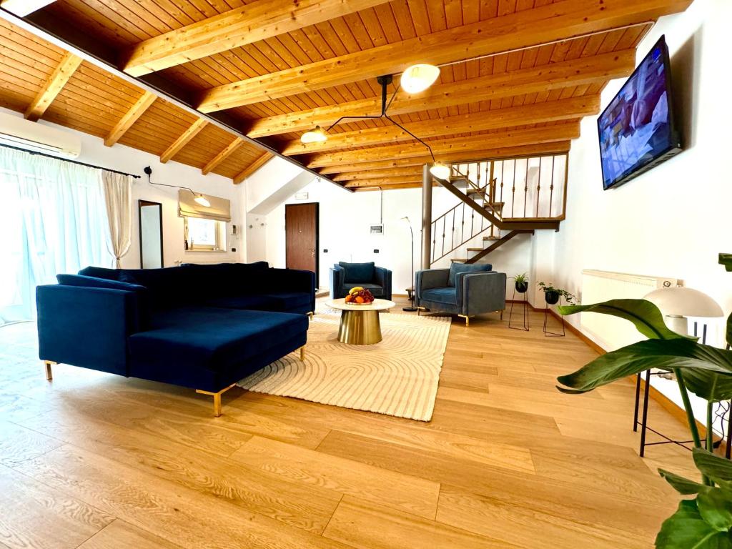 a living room with a blue couch and a tv at Blue Nest in Timişoara