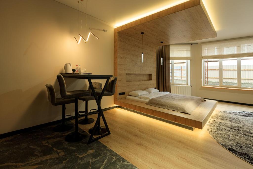 a bedroom with a bed and a desk in it at Discovery Garden apartments in Khmelnytskyi