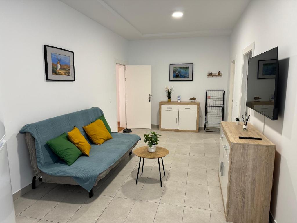 a living room with a couch and a table at Casa Elias - Costa Calma Sun & Beach in Costa Calma