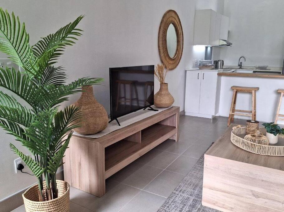 a living room with a fireplace with vases on it at Simbithi Golf Estate Luxury Apartment in Ballito