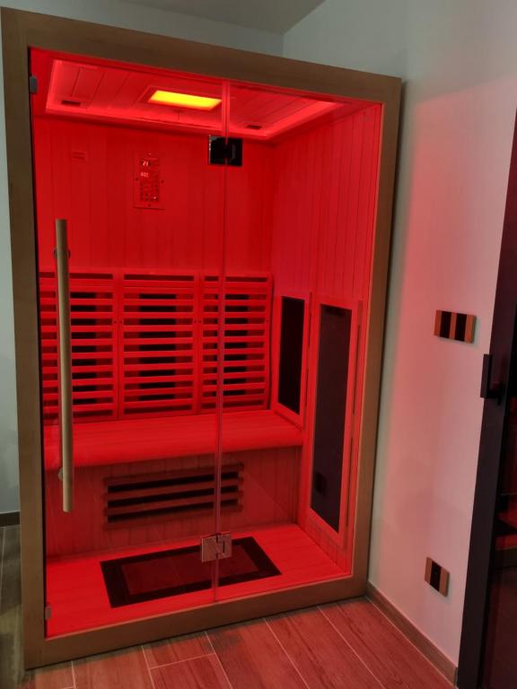 a red shower in a room with red lighting at Le Cocoon in Carpentras