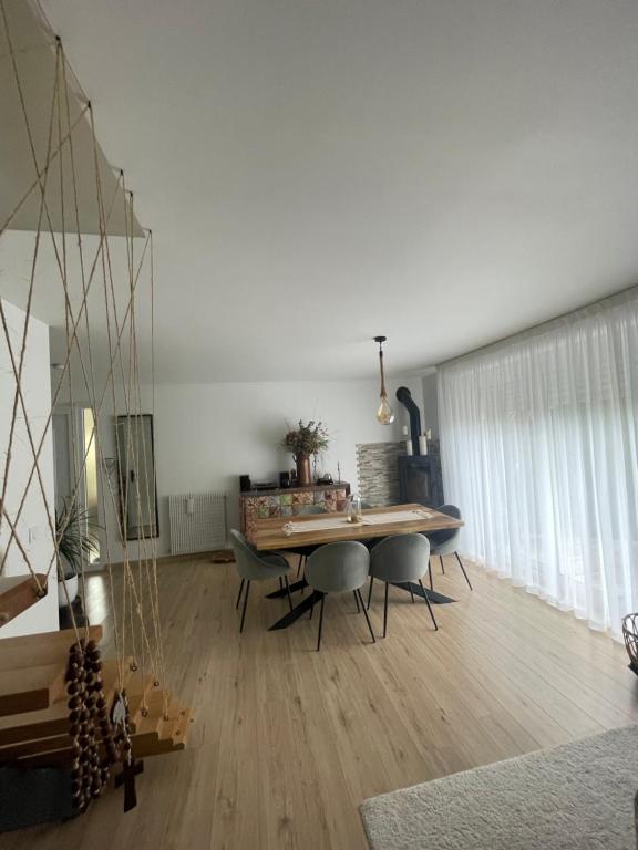 a living room with a wooden table and chairs at DD HOME près PARIS in Viarmes