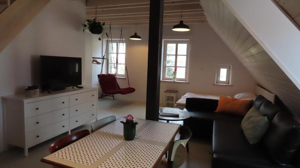a living room with a couch and a table at Domek Kavalírek in Lipova Lazne