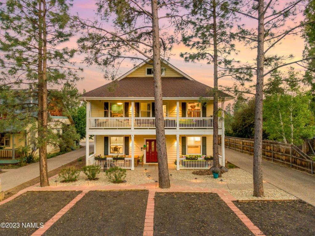 une maison entourée d'une terrasse couverte avec des arbres dans l'établissement 303 BnB Inn Flagstaff, à Flagstaff