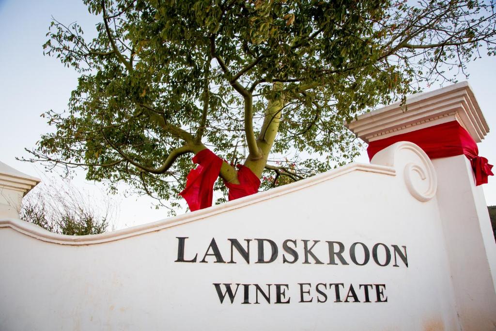 a sign with a tree on top of a wine estate at Landskroon Cottage in Paarl
