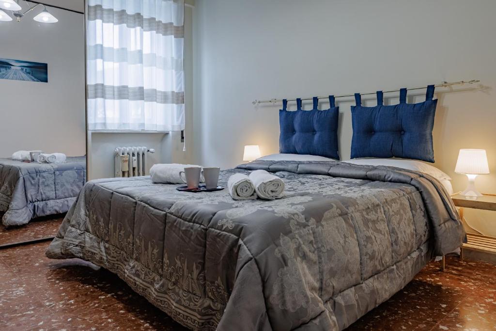 a bedroom with a large bed with blue pillows at Pigneto Smart Apartment in Rome