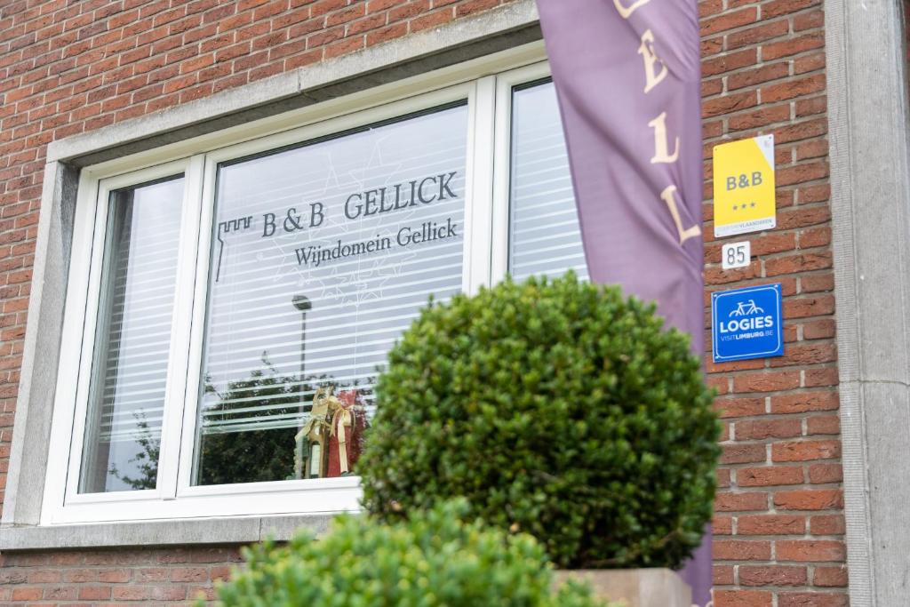 a window of a brick building with a sign in it at B&B Gellick in Lanaken