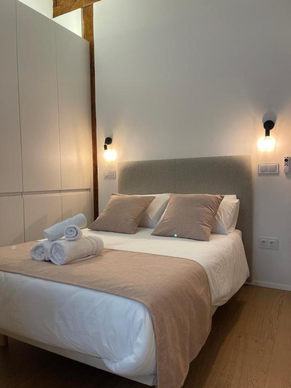 a bedroom with a large bed with towels on it at Estudio en Madrid in Madrid